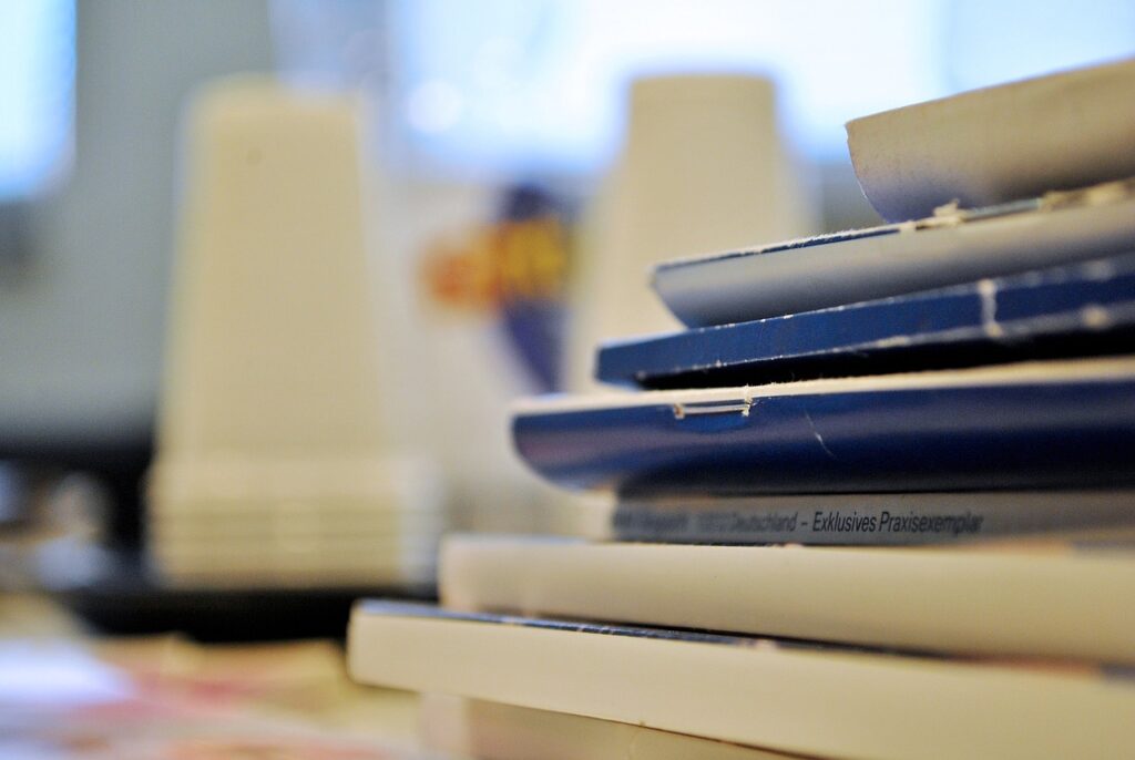 Photo of journals stacked up on a desk
