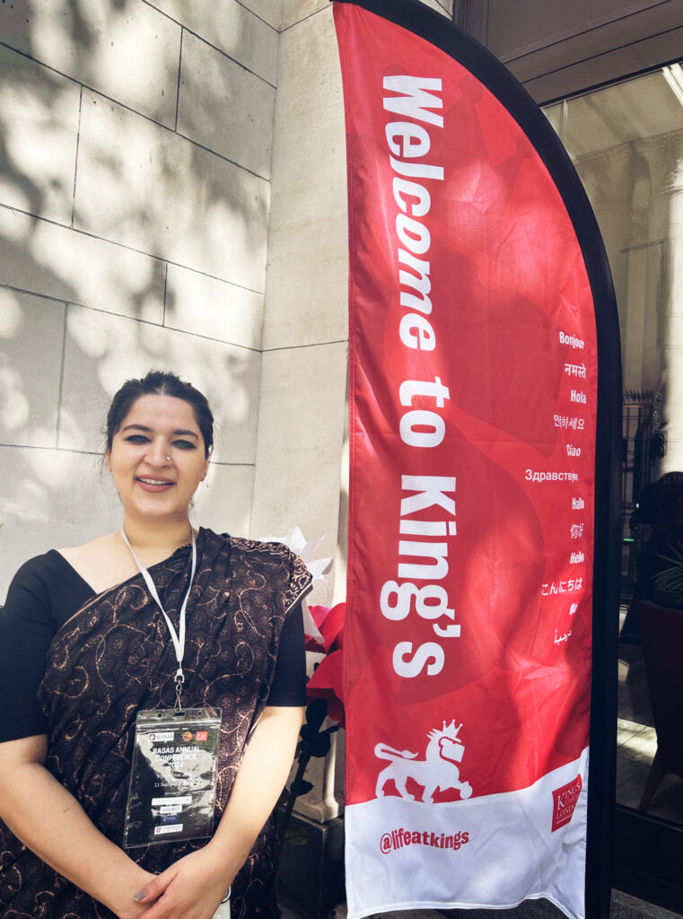 Photo of a woman in front of a sign