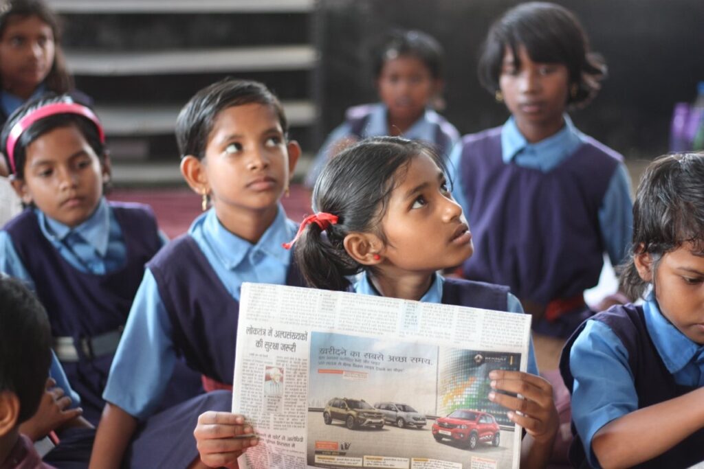 Indian child reading a newspaper