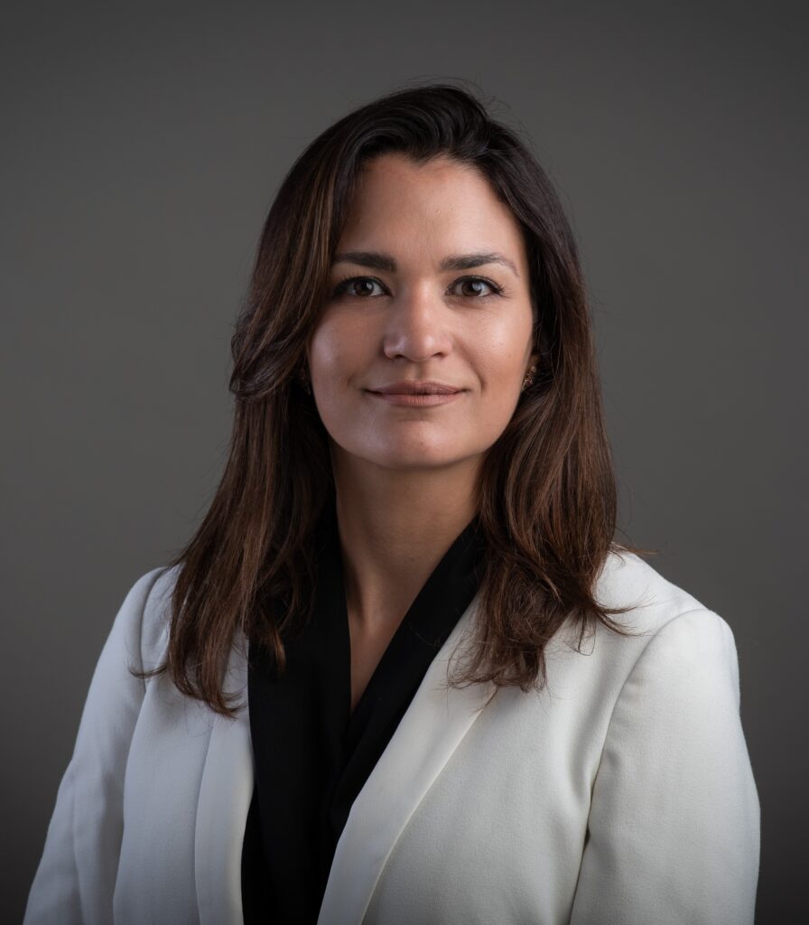 A profile of a woman in white suit