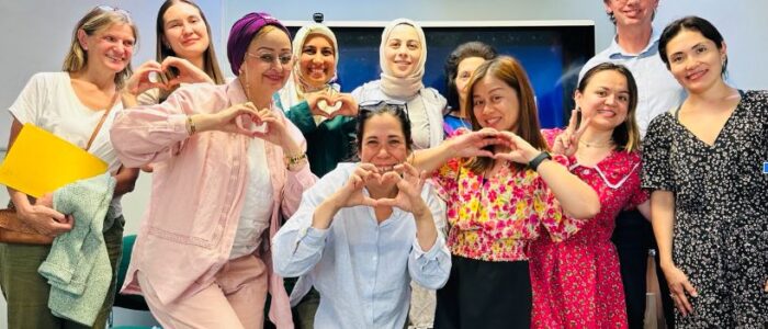 A group of people doing heart shapes with their hands