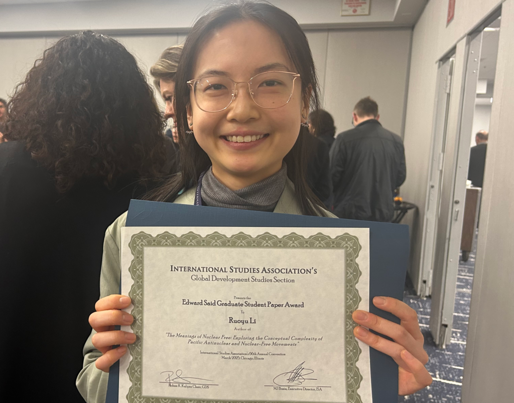 A photo of a woman with a certificate