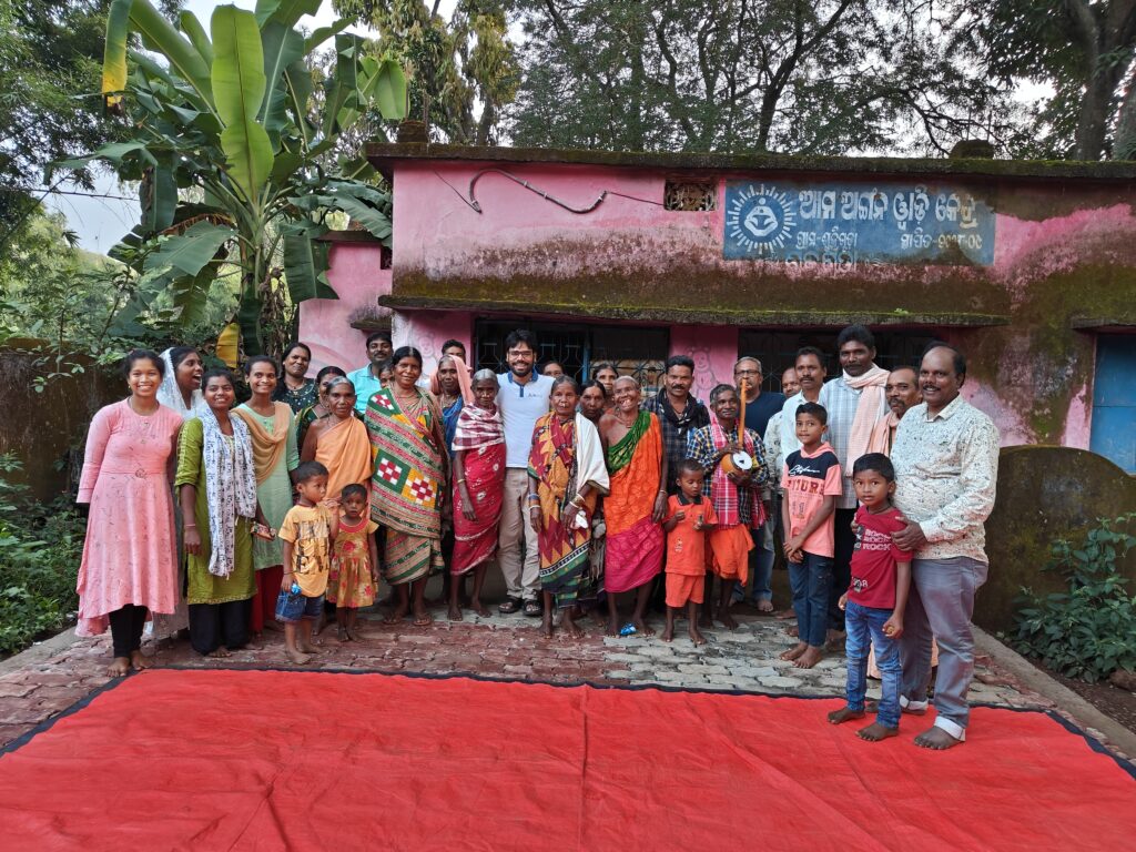 Community members gathered outside and next to a red carpet