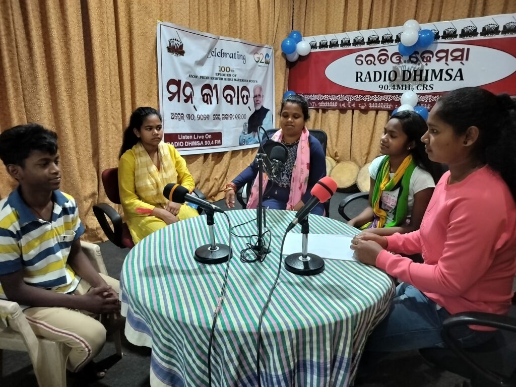 People sitting around a table with microphones