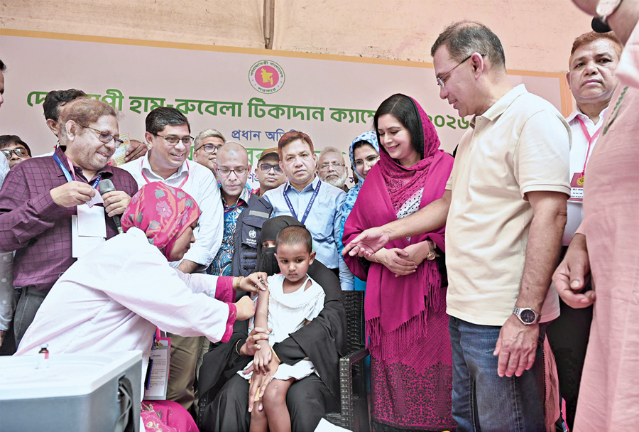 Healthcare workers administer a vaccine to a child during a national immunisation campaign in Banglades