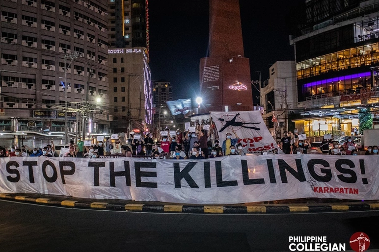 Protest with Stop the Killings banner